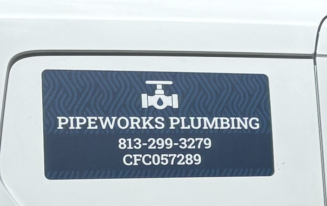 A close-up of the PipeWorks Plumbing logo decal on the van